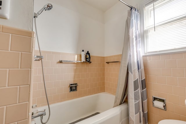 bathroom featuring toilet and shower / bathtub combination with curtain