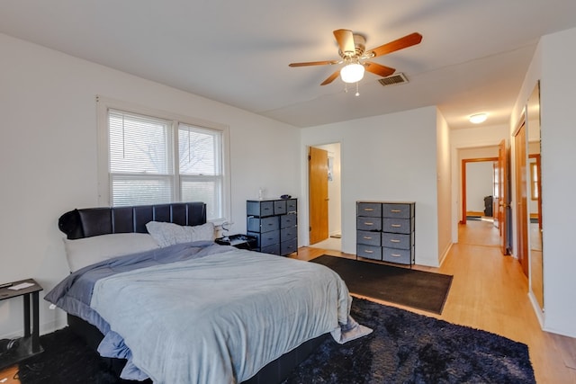 bedroom with ceiling fan and light hardwood / wood-style floors