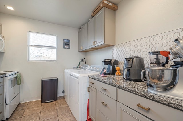 clothes washing area featuring cabinet space and washing machine and clothes dryer