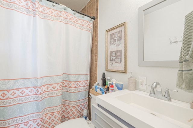 bathroom featuring vanity, toilet, and a shower with curtain