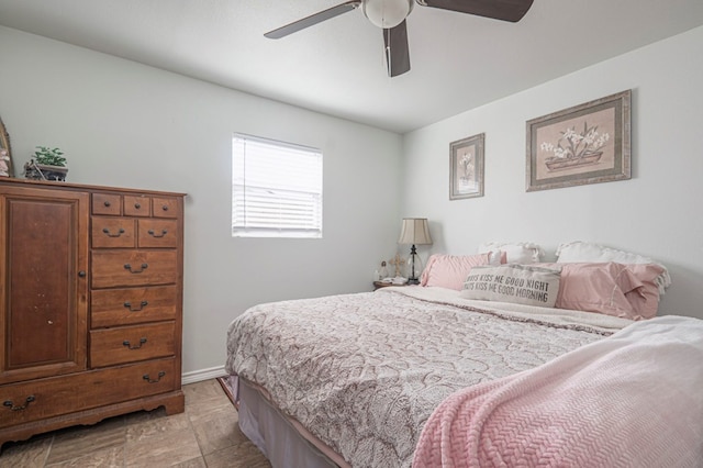 bedroom with ceiling fan and baseboards