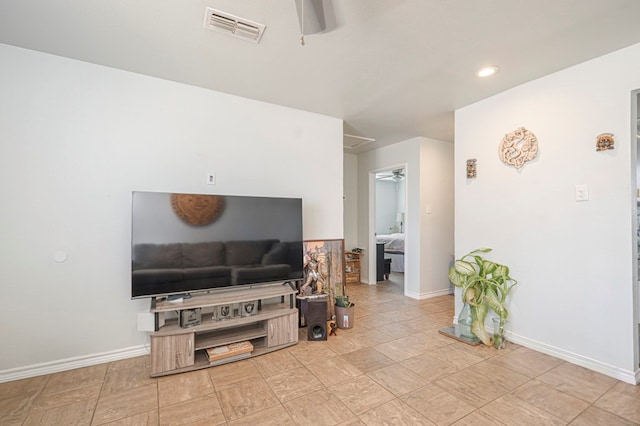 living room featuring baseboards, visible vents, and ceiling fan