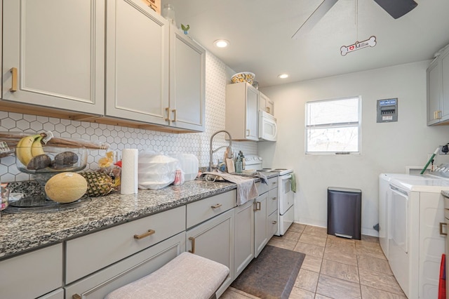 laundry room featuring separate washer and dryer, a sink, cabinet space, and recessed lighting