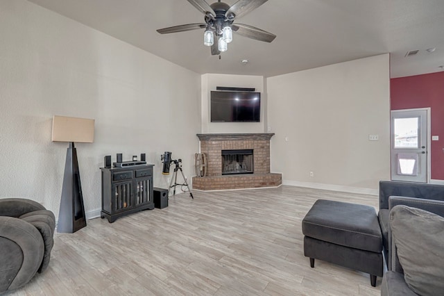 508 E Comiskey, Midland, TX 79706 - living area featuring a ceiling fan, light wood-style flooring, a brick fireplace, and baseboards