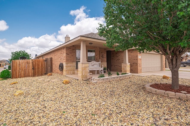 508 E Comiskey, Midland, TX 79706 - view of front of home with brick siding, driveway, a chimney, and fence