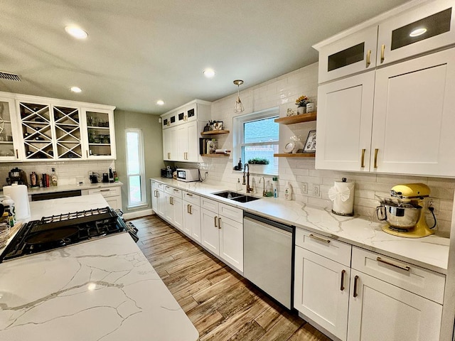 1303 Terra Ct, Midland, TX 79705 - kitchen with dishwasher, open shelves, tasteful backsplash, wood finished floors, and recessed lighting