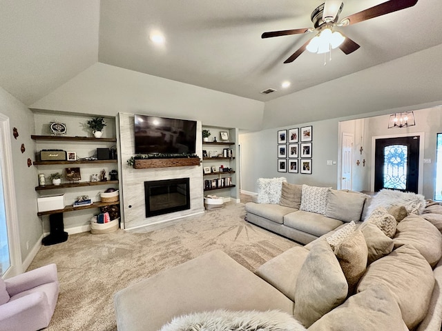 1303 Terra Ct, Midland, TX 79705 - living area featuring lofted ceiling, a fireplace, ceiling fan, carpet flooring, and a chandelier