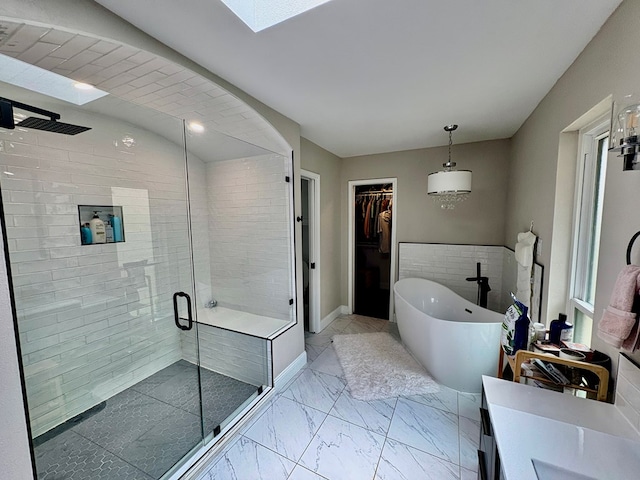 1303 Terra Ct, Midland, TX 79705 - full bath featuring a stall shower, a freestanding bath, a walk in closet, marble finish floors, and vanity