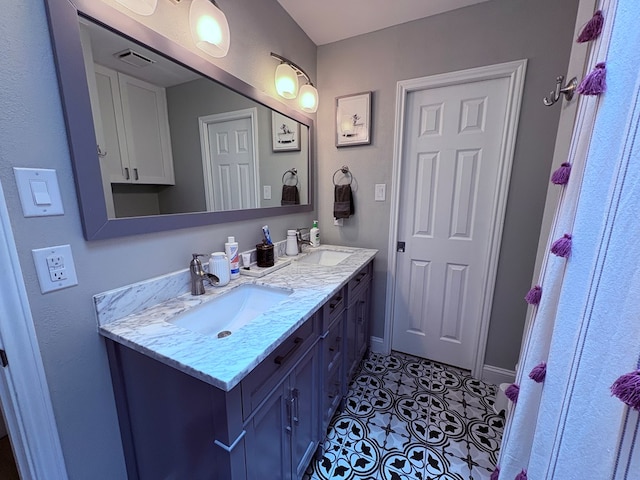1303 Terra Ct, Midland, TX 79705 - bathroom with double vanity and tile patterned floors