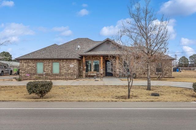 single story home with brick siding and roof with shingles