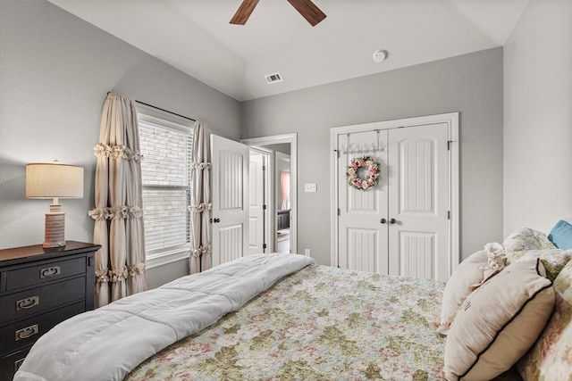 bedroom with a ceiling fan, visible vents, and a closet