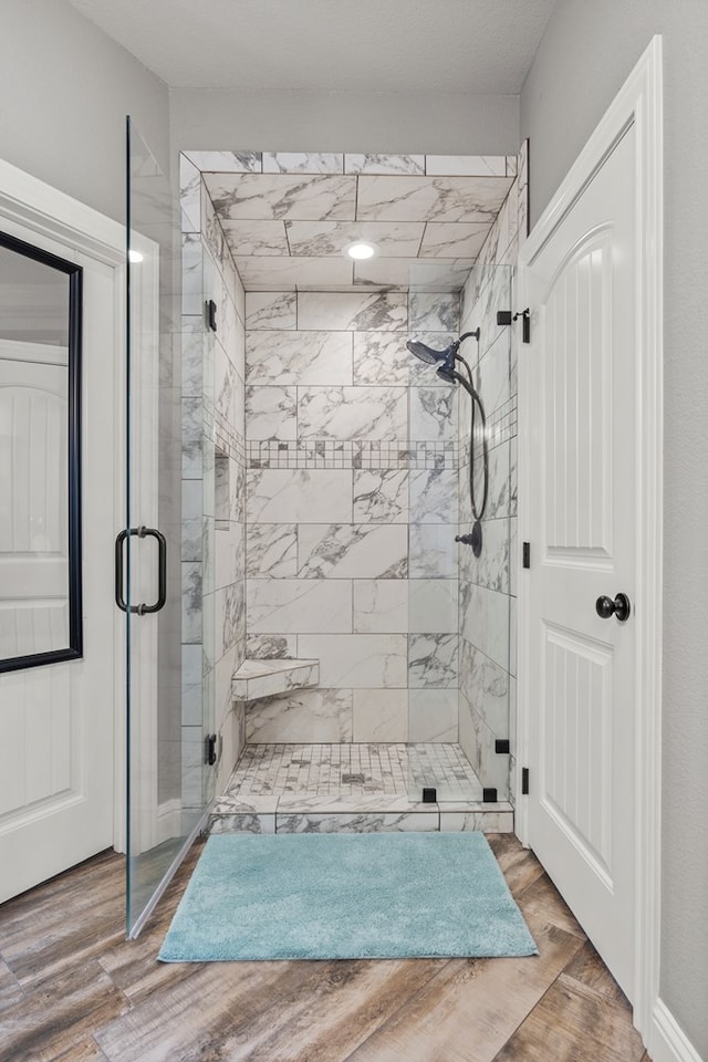 bathroom featuring a stall shower and wood finished floors