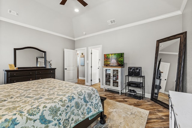 bedroom featuring dark wood finished floors, visible vents, crown molding, and baseboards