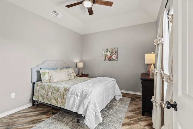 bedroom with dark wood-type flooring, visible vents, and baseboards