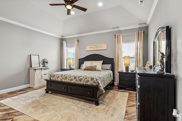 bedroom with vaulted ceiling, multiple windows, visible vents, and crown molding