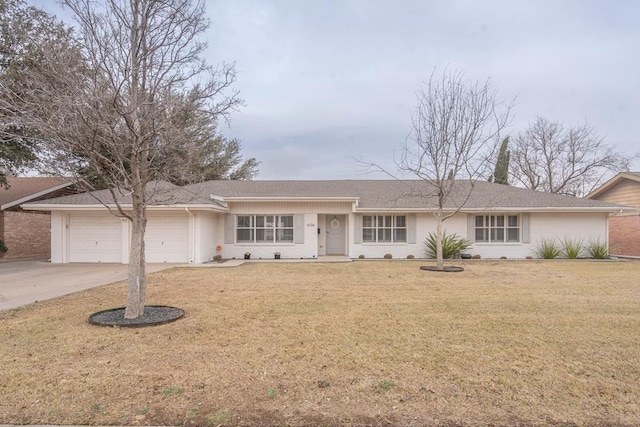 single story home featuring a front yard, brick siding, driveway, and an attached garage