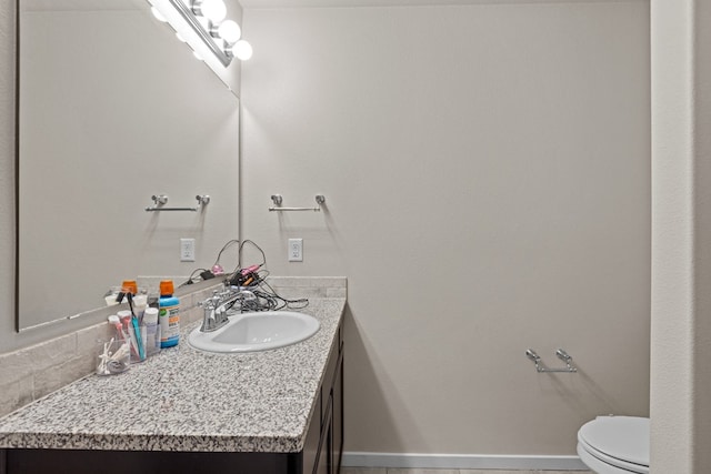 bathroom featuring tile patterned flooring, vanity, and toilet