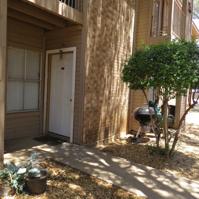 4700 Boulder Ave Unit 611, Midland, TX 79707 - view of exterior entry featuring a balcony and brick siding
