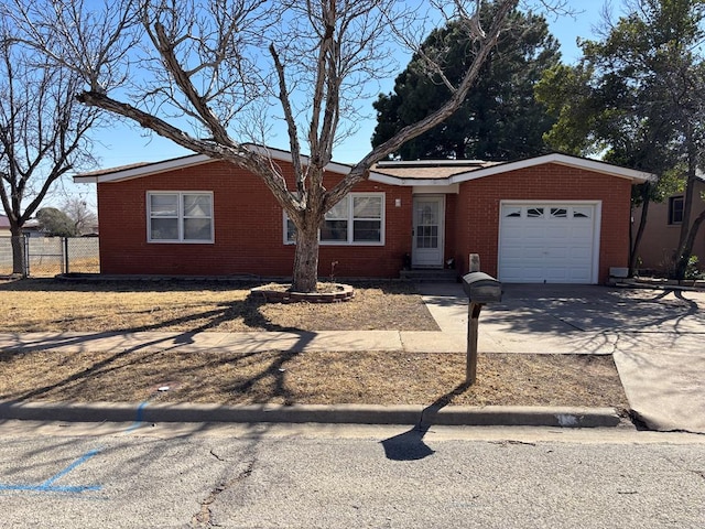 ranch-style house featuring brick siding, driveway, a garage, and fence