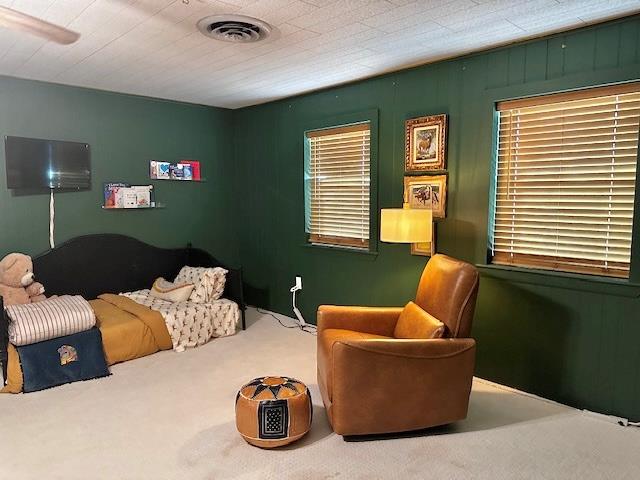 bedroom with multiple windows and carpet floors