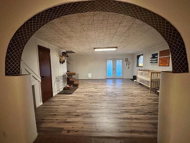 hallway featuring hardwood / wood-style flooring and french doors