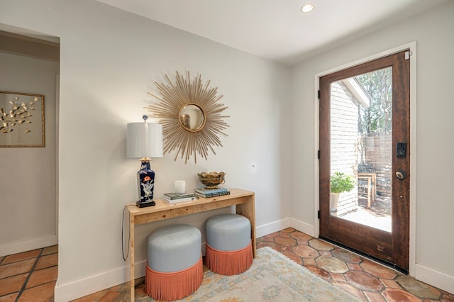 doorway to outside featuring light tile patterned flooring