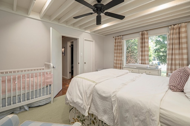 bedroom with ceiling fan and beamed ceiling