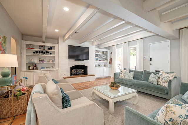 living room with a fireplace, beam ceiling, and built in features