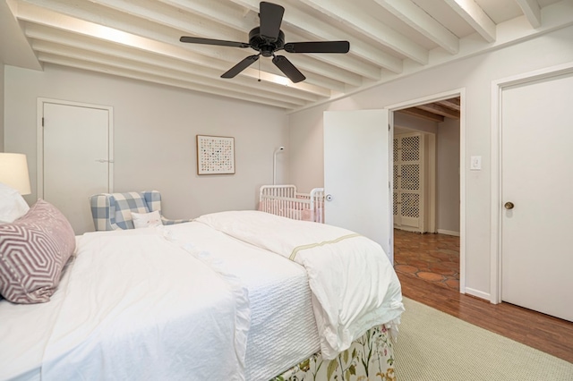 bedroom featuring beamed ceiling, ceiling fan, and wood-type flooring