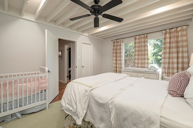 bedroom with beam ceiling and ceiling fan