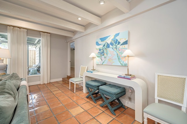 sitting room with beamed ceiling and light tile patterned floors