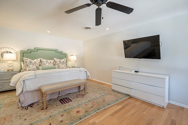 bedroom with ceiling fan and light hardwood / wood-style flooring