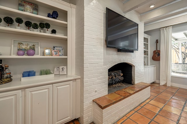 tiled living room with a brick fireplace