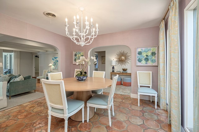 dining space featuring a notable chandelier