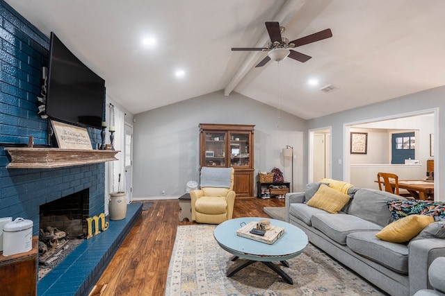 living room with wood finished floors, ceiling fan, a fireplace, and baseboards