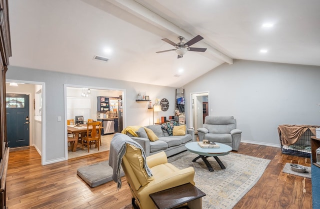 living room with hardwood / wood-style flooring, ceiling fan, and baseboards