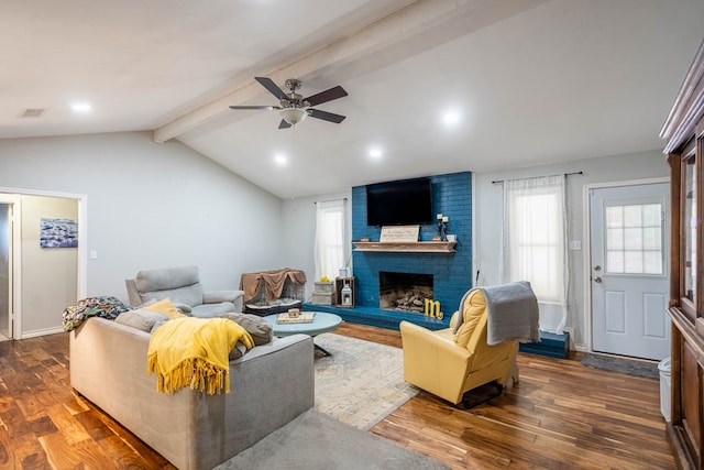 living room with dark wood finished floors, ceiling fan, and a brick fireplace