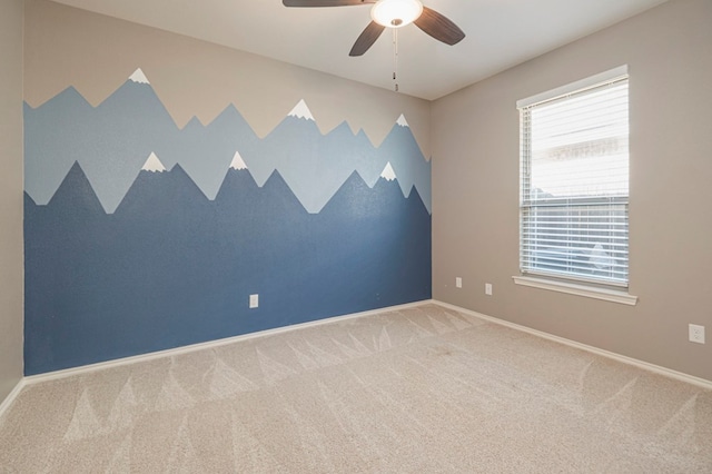 carpeted empty room featuring ceiling fan