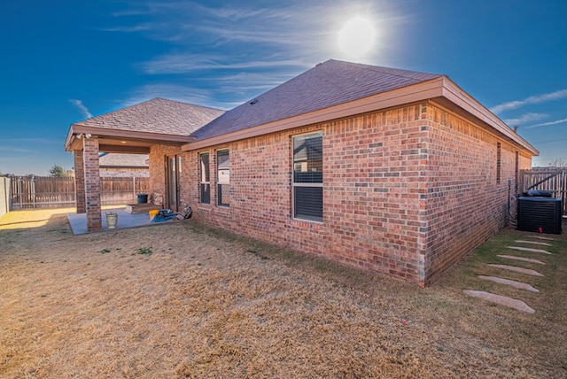 view of property exterior with central AC unit and a patio area