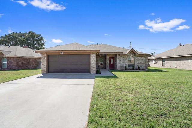 4910 Rio Grande Ave, Midland, TX 79707 - view of front of home featuring a garage, driveway, a front lawn, and brick siding