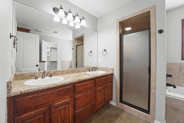 4910 Rio Grande Ave, Midland, TX 79707 - bathroom with double vanity, a stall shower, a bath, and tile patterned floors