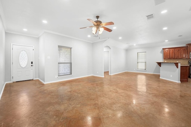 4910 Rio Grande Ave, Midland, TX 79707 - unfurnished living room featuring a ceiling fan, plenty of natural light, arched walkways, concrete floors, and recessed lighting