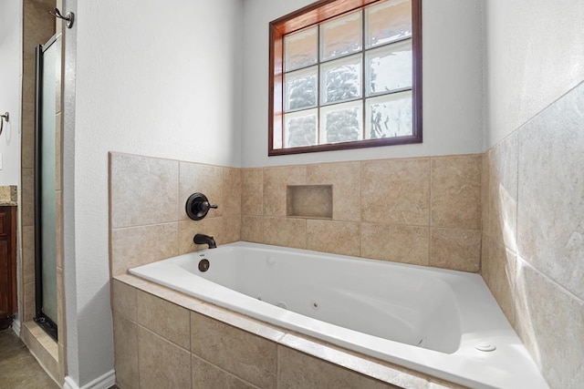 4910 Rio Grande Ave, Midland, TX 79707 - bathroom with a jetted tub, vanity, and a stall shower