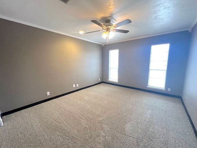 empty room featuring crown molding, light colored carpet, and ceiling fan