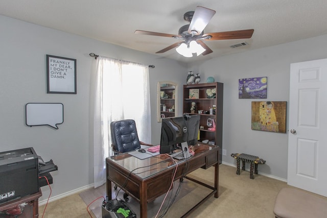 home office with ceiling fan, baseboards, visible vents, and light colored carpet