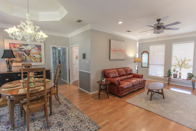 dining room featuring wood finished floors, visible vents, and crown molding