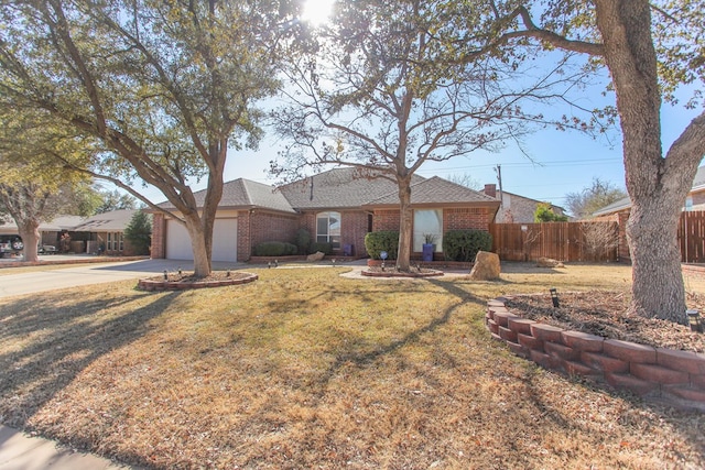 single story home featuring an attached garage, brick siding, fence, concrete driveway, and a front lawn