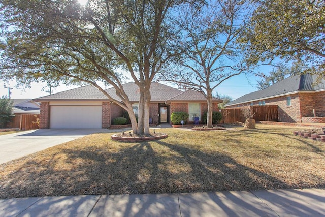 ranch-style house with a garage, brick siding, fence, driveway, and a front yard