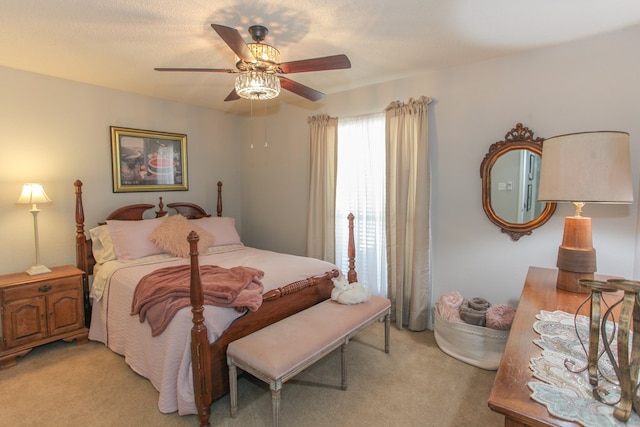 bedroom with a ceiling fan and light colored carpet