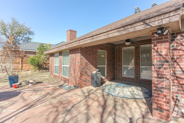 view of patio featuring ceiling fan and fence